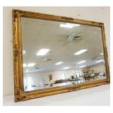 1160	BEVELED GLASS MIRROR IN ORNATE GILT FINISHED FRAME, APPROXIMATELY 29 IN X 42 IN