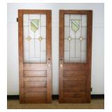 1031	PAIR OF WOOD DOORS W/LEADED GLASS PANEL, ONE DOOR W/GLASS DAMGE, EACH APPROXIMATELY 29 3/4 IN X