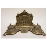 1055	ORNATE BRASS VICTORIAN LETTER HOLDER & DOUBLE INKWELL, INKWELL INSERTS MISSING, APPROXIMATELY 8