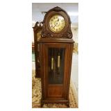 1139	GERMAN GRANDFATHERS CLOCK IN OAK CASE W/APPLIED CARVINGS ON BONNET, NO PENDULUM, APPROXIMATELY 