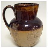 1091	DOULTON LAMBERH PITCHER WITH EMBOSSED DUTCH PEOPLE AND WINDMILL, APPROXIMATELY 6 3/4 IN