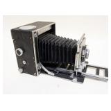 1043	DAWE UNIVERSAL PRESS CAMERA, SHUTTER DAMAGED AND WILL NOT CLOSE