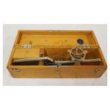1180	ANTIQUE SURGICAL STAPLER IN OAK BOX W/KEY, APPROXIMATELY 18 IN X 5 IN X 5 IN