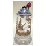 1058	BAVARIAN CRYSTAL STEIN WITH ETCHED GLASS, SCENE HAVING GILT ACCENTS, JEWELED RUBY PEWTER LID, A