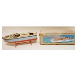 1297A	TOY MOTORIZED BOAT IN ORIGINAL BOX, SOME PAINT LOSS