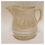 1150	YELLOWARE PITCHER W/LIGHT BLUE & CREAM BANDING, APPROXIMATELY 7 IN HIGH