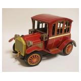 1328	TIN BATTERY OPERATED ANTIQUE STYLE CAR