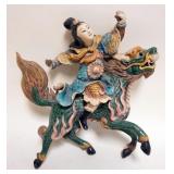 1159	ASIAN GLAZED POTTERY WALL HANGING WITH IMAGE OF PERSON RIDING FOO DOG , APPROXIMATELY 11 IN H W