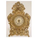1119	ORNATE GILT CAST METAL DRESSER CLOCK, APPROXIMATELY 7 IN HIGH