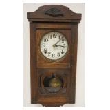 1121	SMALL GERMAN WALL OAK CLOCK, APPROXIMATELY 9 IN X 5 IN X 19 IN HIGH
