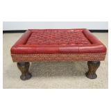 1233	RED LEATHER UPHOLSTERED AND TUFTED TOP HASSOCK ON TURNED FLUTED WOOD LEGS, APPROXIMATELY 36 INX