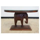 1244	SOLID MAHOGANY OVAL ELEPHANT TABLE WITH GLASS TOP, APPROXIMATELY 35 IN X 24 IN X 22 IN