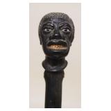 1039	ANTIQUE FOLK ART AMERICAN CARVED BLACK HEAD WALKING STICK W/DETAILED CARVING, GLASS EYES & CARV