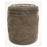 1014	ASIAN WOOD CARVED COVERED JAR W/CARVED IMAGES ALL AROUND, APROXIMATELY 7 1/2 IN HIGH