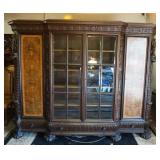 1101	ANTIQUE OAK CARVED GERMAN CABINET HAVING 2 BURLED PANEL DOORS, 3 INDIVIDUAL PANED GLASS CENTER 