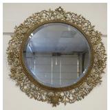 1148	ROUND BEVELED EDGE MIRROR IN ORNATE WREATH LIKE CAST BRASS FRAME W/SCONCE HOLDERS