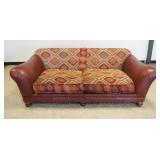 1121	ROCHE BUBOIS SOFA, UPHOLSTERED CUSHIONS W/BROWN LEATHER ARMS & BASE HAVING BRASS TACK ACCENTS, 