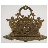 1050	ANTIQUE BRASS BRADLEY & HUBBARD LETTER HOLDER. HAVING 3 SECTIONS FLANKED BY IMAGES OF CHERUBS, 