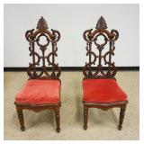 1117	PAIR OF ANTIQUE CARVED OAK GOTHIC STYLE CHAIRS W/LIFT SEATS, EACH APPROXIMATELY 51 IN HIGH
