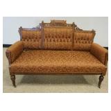 1134	WALNUT VICTORIAN UPHOLSTERED SETTEE W/CARVED CREST & TUFTED BACK, APPROXIMATELY 58 IN X 24 IN X