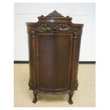 1153	OAK BLIND DOOR HALF ROUND CHINA CABINET W/3 INTERIOR SHELVES, MIRROR BACK & SERPENT CARVED CRES