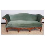 1127	UPHOLSTERED SOFA WITH HEAVILY CARVED WALNUT SKIRT AND ARMS, APPROXIMATELY 84 IN X 32 IN X 45 IN