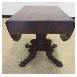 1156	EMPIRE MAHOGANY DROP LEAF TABLE ON HEAVILY CARVED CLAW FOOT AND PEDESTAL BASE, APPROXIMATELY 39