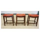1206	SADDLE SHAPED STOOLS, VINYL WITH BRASS TACK ACCENTS, EACH APPROXIMATELY 21 IN X 14 IN X 25 IN H
