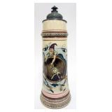 1072	LARGE GERMAN STEIN WITH COMICAL IMAGE OF GOAT JUMPING OUT OF A WOOD KEG, APPROXIMATELY 16 IN H,