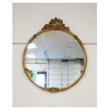 1215	ORNATE GILT EDGE ROUND HANGING MIRROR WITH SCROLLED FLORAL CREST, APPROXIMATELY 30 IN X 36 IN