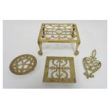 1069	GROUP OF ANTIQUE BRASS TRIVETS, LARGEST APPROXIMATELY 9 IN X 8 IN X 5 IN H