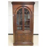 1217	STATTON BLACK CHERRY CORNER CABINET HAVING 4 DOORS, INTERIOR LIGHTING ON BRACKET FEET, SCALLOPE