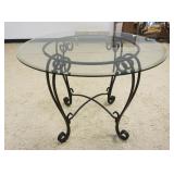 1238	GLASS TOP BEVELED EDGE TABLE WITH WROUGHT IRON BASE, APPROXIMATELY 42 IN X 30 IN H