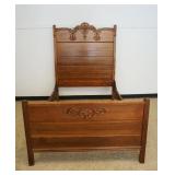 1253	ANTIQUE OAK HIGH BACK BED WITH APPLIED CARVINGS, APPROXIMATELY 57 IN X 77 IN X 75 IN H