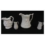 1126	GROUP OF 4 PARIAN PORTMERION PITCHERS, TALLEST APPROXIMATELY 9 IN HIGH