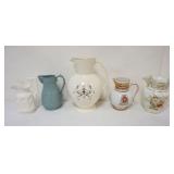 1129	GROUP OF ASSORTED PITCHERS INCLUDING WEDGWOOD, LENOX, LARGEST PIECE APPROXIMATELY 13 IN
