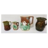 1148	4 MAJOLICA PITCHERS, LARGEST APPROXIMATELY 10 IN HIGH