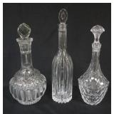 1157	3 CRYSTAL DECANTORS, LARGEST APPROXIMATELY 14 IN HIGH