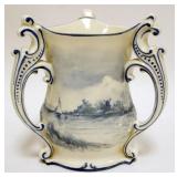 1034	AMERICAN BELLEEK CERAMIC ART COMPANY DELFT 3 HANDLE LOVING CUP, APPROXIMATELY 7 1/2 IN H