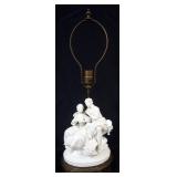 1069	PARIAN TABLE LAMP ON METAL BASE WITH IMAGE OF COURTING SCENE, APPROXIMATELY 24 IN, OVERALL