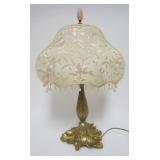 1076	BRASS BOUDIOR LAMP WITH LEAF SHAPED BASE AND EMBROIDERED PINK FLORAL SHADE, APPROXIMATELY 22 IN