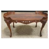 1295	PETITE MAHOGANY COFFEE TABLE WITH PIERCED CARVED WOOD SKIRT AND GALLERY SIDES