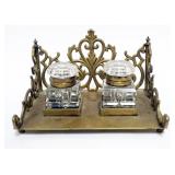 1001	ANTIQUE DOUBLE INKWELL W/CUT GLASS INKWELLS IN ORNATE BRASS BASE, APPROXIMATELY 6 1/2 IN X 4 1/
