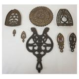 1101	GROUP OF ASSORTED ANTIQUE TRIVETS INCLUDING CAST IRON GRISWOLD, LARGEST APPROXIMATELY 12 IN X 7