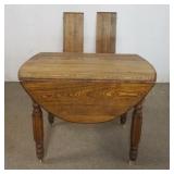 1174	OAK DROP LEAF TABLE WITH 2 LEAVES, APPROXIMATELY 42 IN X 28 IN X 30 IN H CLOSED, EACH DROP 13 I