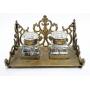 1001	ANTIQUE DOUBLE INKWELL W/CUT GLASS INKWELLS IN ORNATE BRASS BASE, APPROXIMATELY 6 1/2 IN X 4 1/