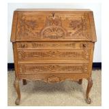 1287	CARVED OAK SLANT FRONT DESK WITH KEY AND 2 DRAWERS AND PANELED SIDES, APPROXIMATELY 33 IN X 16 