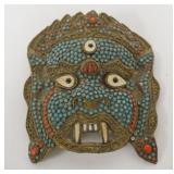 1071	PERSIAN MASK ORNATE HAND TOOLED BRASS W/APPLIED STONES, APPROXIMATELY 7 IN X 8 IN