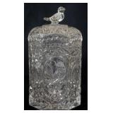 1142	PRESS GLASS CRACKER JAR WITH IMAGES OF BIRDS AND BIRD FINIAL TOP, APPROXIMATELY 9 IN H