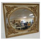 1086	OVAL HANGING MIRROR IN ORNATE SILVER AND GILT FINISHED FRAME, APPROXIMATELY 25 IN X 23 IN